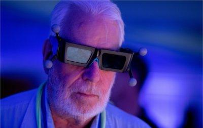 A guest at the X>Studio exhibit tries on a pair of stereoscopic 3D glasses.